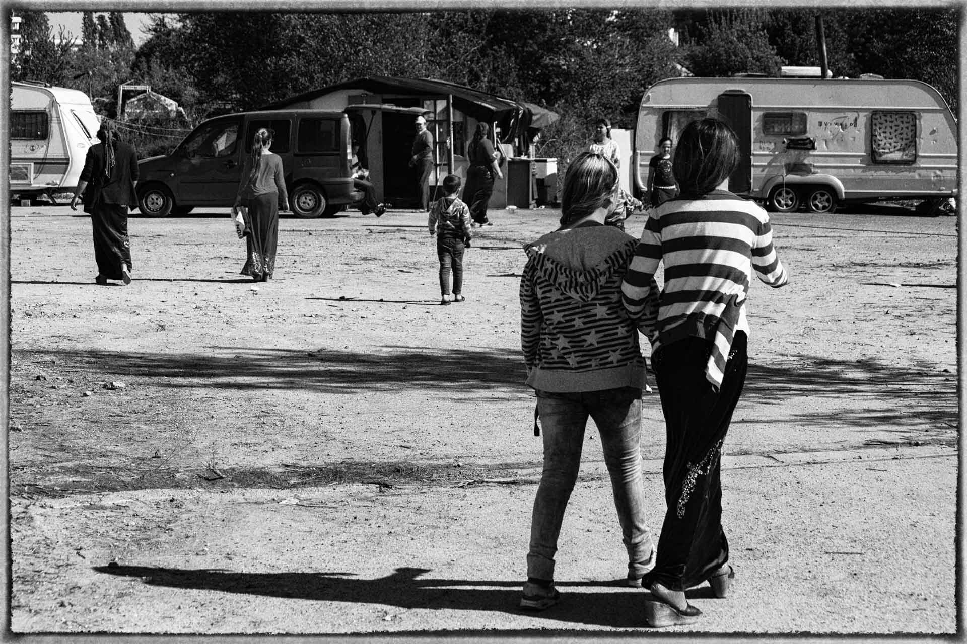 Deux jeunes roms marchent dans un camp à Bordeaux.